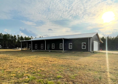 Image shows A Black residential Metal Barndominium with a grey roof | Phoenix Building Solutions | Metal Buildings | Barndominiums | Pole Barns | Custom Metal Orders