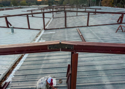Image shows a Metal Framed roof structure being built at Matachie High School | Phoenix Building Solutions | Metal Buildings | Barndominiums | Pole Barns | Custom Metal Orders